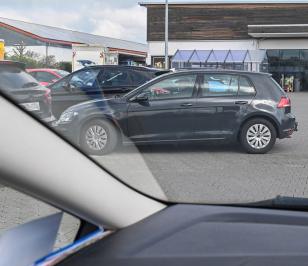 Mann parkt auf einem Parkplatz