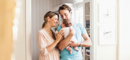 Junge Eltern mit Baby auf dem Arm