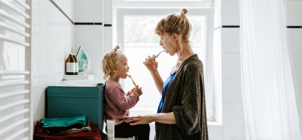 Mutter und Tochter putzen Zähne