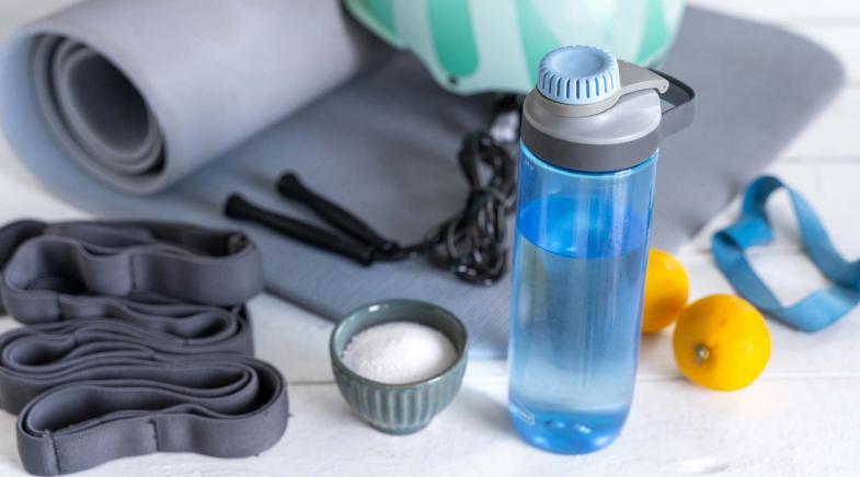 Iso-Getränk in einer Flasche neben einer Yogamatte