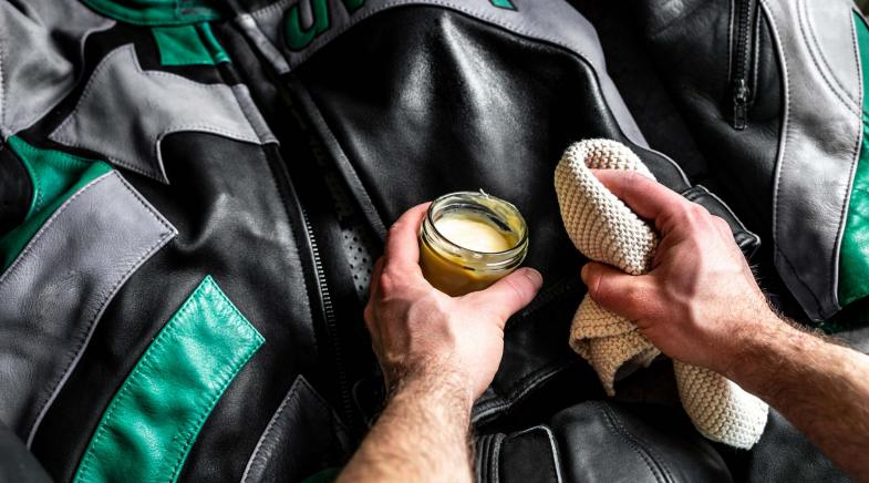 Motorradjacke wird mit Lederpflege eingerieben