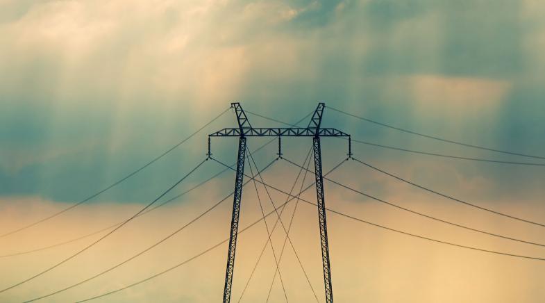 Hochspannungsmast vor Regenwolken