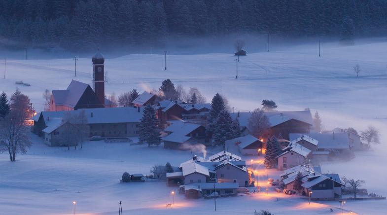 Winterlandschaft mit Häusern und Wälder bei Nacht